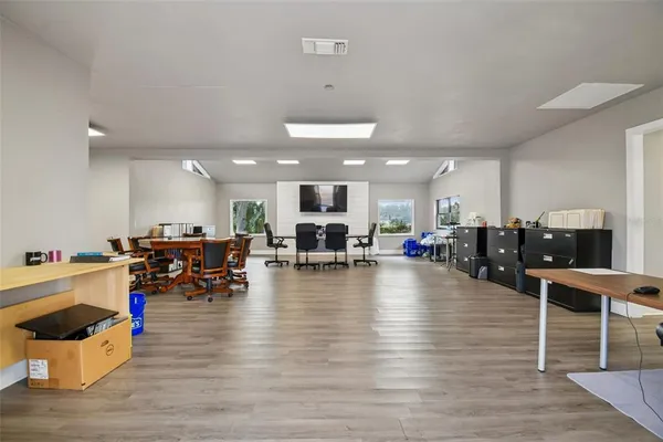 a view of a hallway with wooden floor and closet