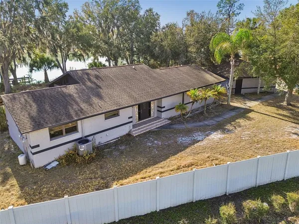 an aerial view of lake and residential houses with outdoor space