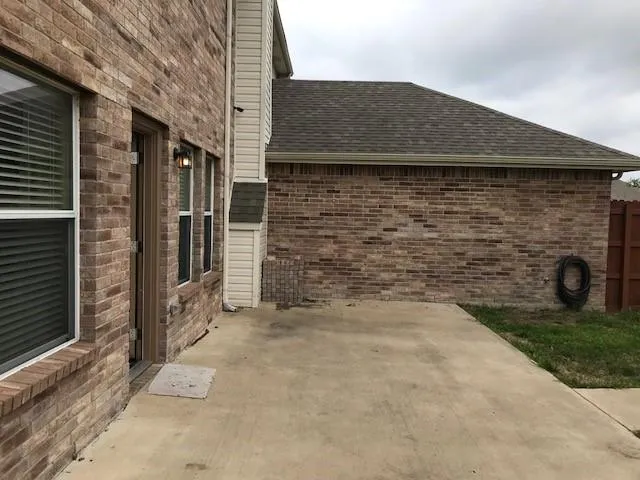 a brick building with a bench in front of door