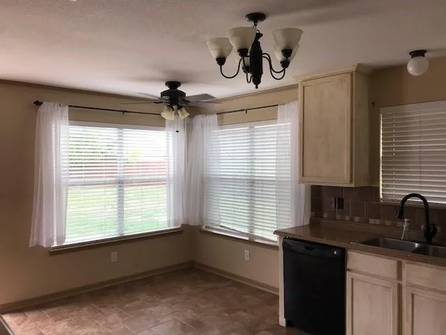 a kitchen with a window appliances cabinets and furniture