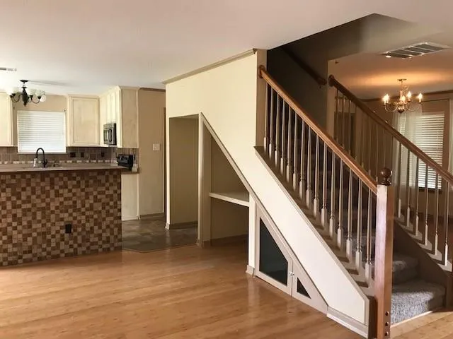 a view of entryway with stairs and wooden floor