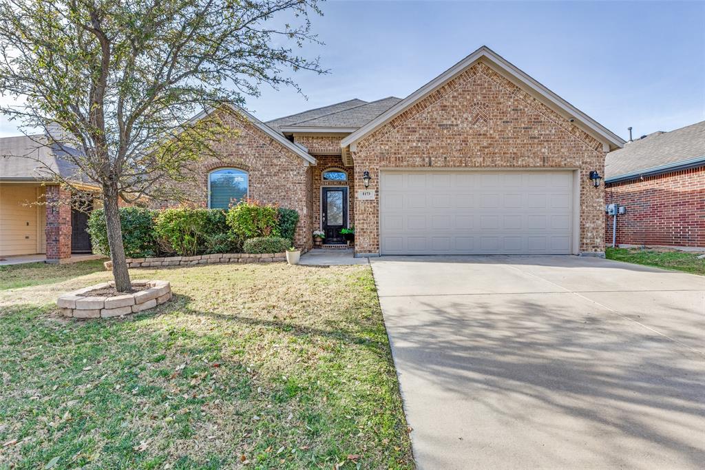 1173 Roping Reins Way Fort Worth, TX 76052 - Photo 1 of 24 View of front of home featuring a garage, driveway, brick siding, a front lawn, and a shingled roof