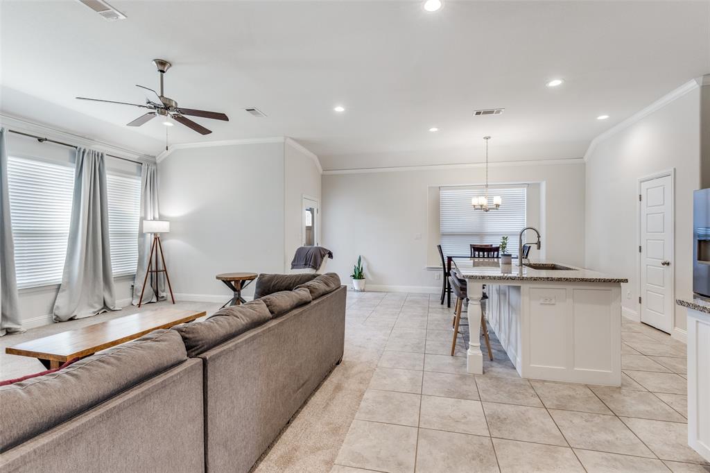 1173 Roping Reins Way Fort Worth, TX 76052 - Photo 10 of 24 Living area with a ceiling fan, light tile patterned floors, crown molding, and suspended lighting