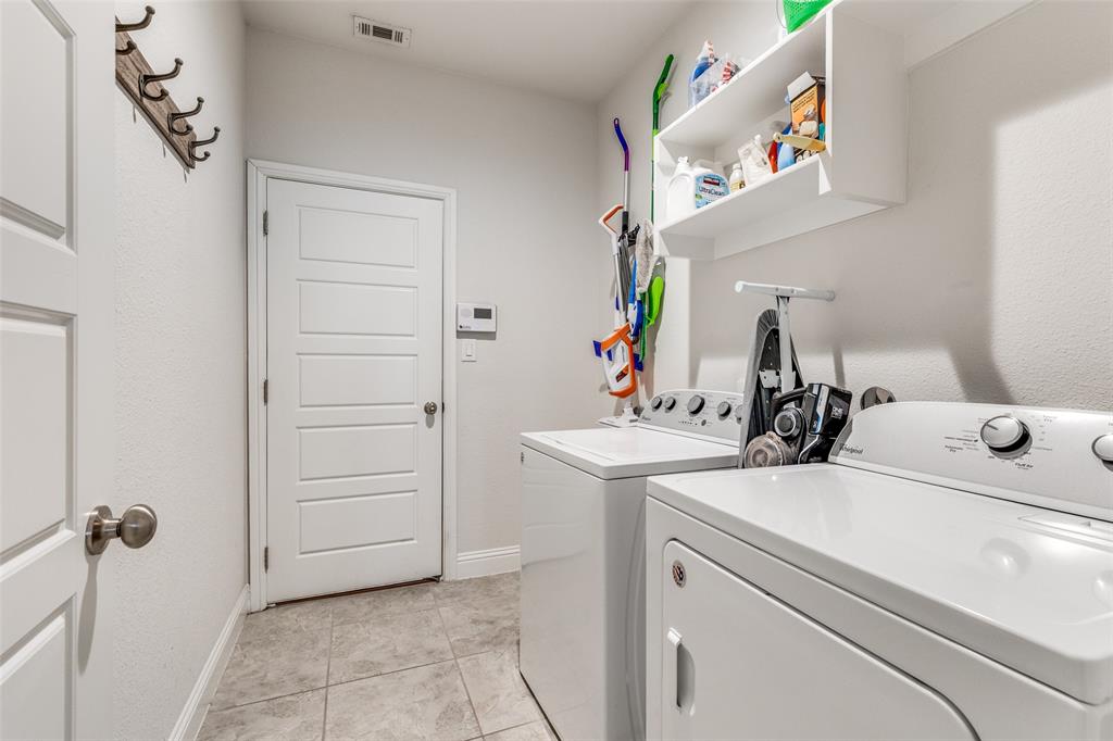 1173 Roping Reins Way Fort Worth, TX 76052 - Photo 21 of 24 Laundry room featuring washer and clothes dryer and light tile patterned floors