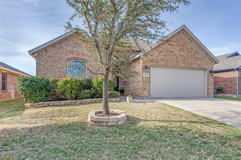 1173 Roping Reins Way Fort Worth, TX 76052 - Photo 3 of 24 Traditional-style house featuring a garage, a front lawn, brick siding, and concrete driveway