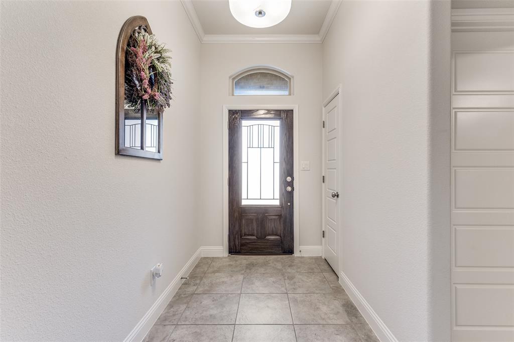 1173 Roping Reins Way Fort Worth, TX 76052 - Photo 5 of 24 Foyer entrance featuring crown molding and light tile patterned flooring