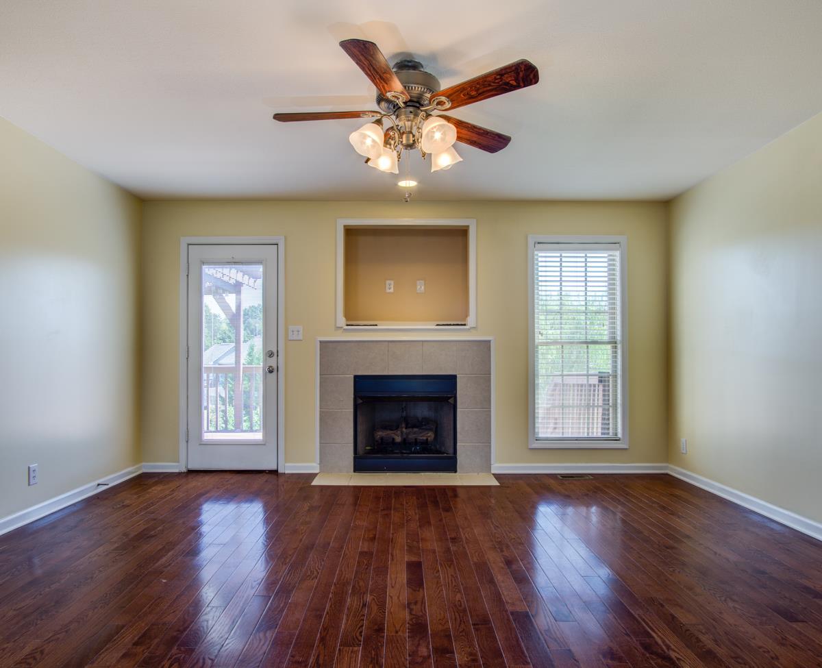 1031 Bluejay Lane Adams, TN 37010 - Photo 5 of 19 Fireplace with great view of backyard and lots of natural light