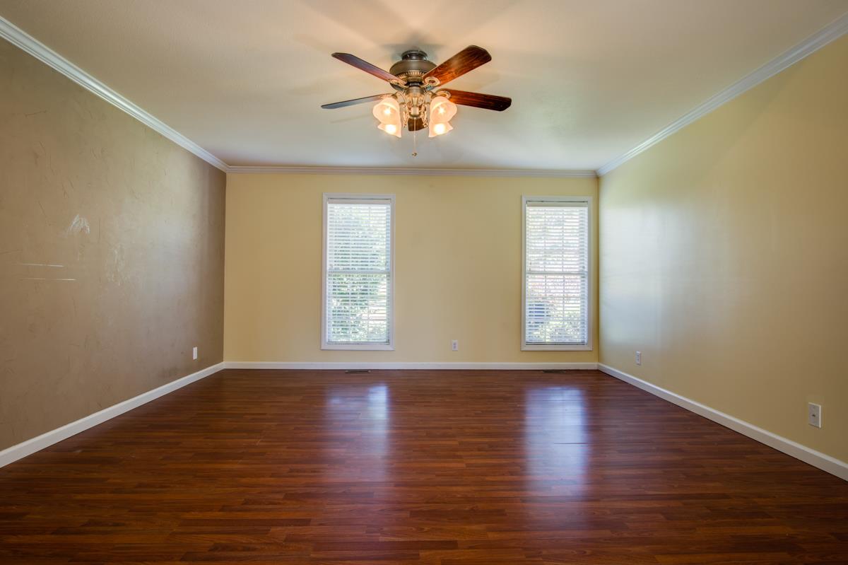 1031 Bluejay Lane Adams, TN 37010 - Photo 9 of 19 Spacious MAIN FLOOR master bedroom with floor to ceiling windows and a textured accent wall