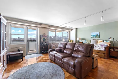 a living room with furniture and a floor to ceiling window