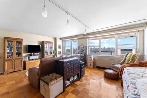 a bed room with furniture and a large window