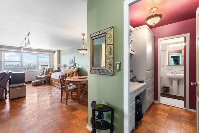 a living room with furniture window and wooden floor