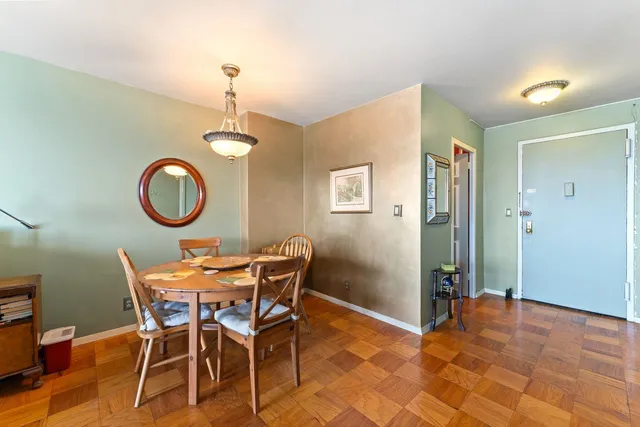 a dining room with furniture and a mirror