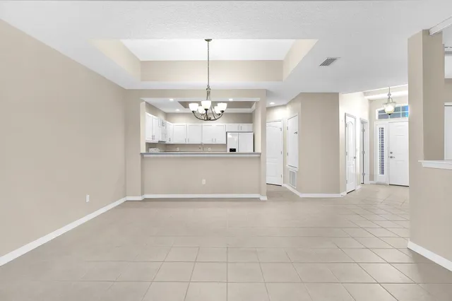 a view of a kitchen with a sink and chandelier