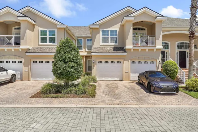 an aerial view of a house with a swimming pool and garden