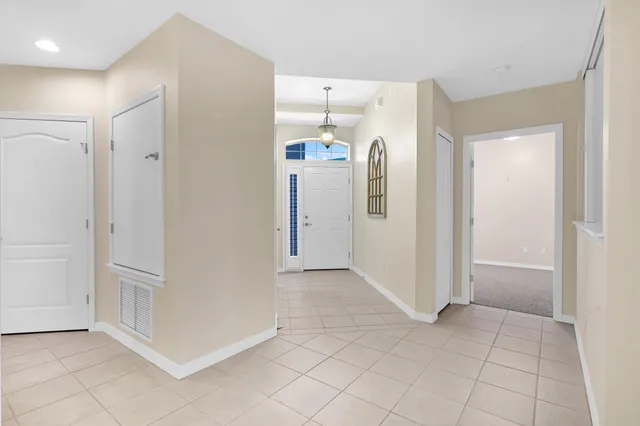 an empty room with closet and windows