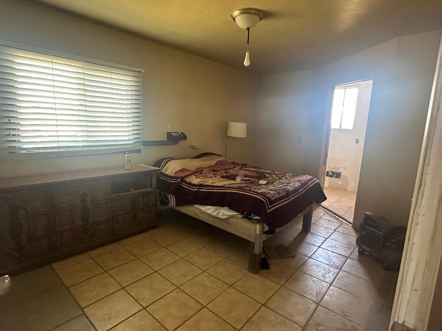 7599 Ave 152 Tipton, CA 93272 - Photo 8 of 17 a bedroom with a bed and a window