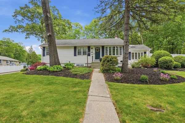a front view of a house with a garden