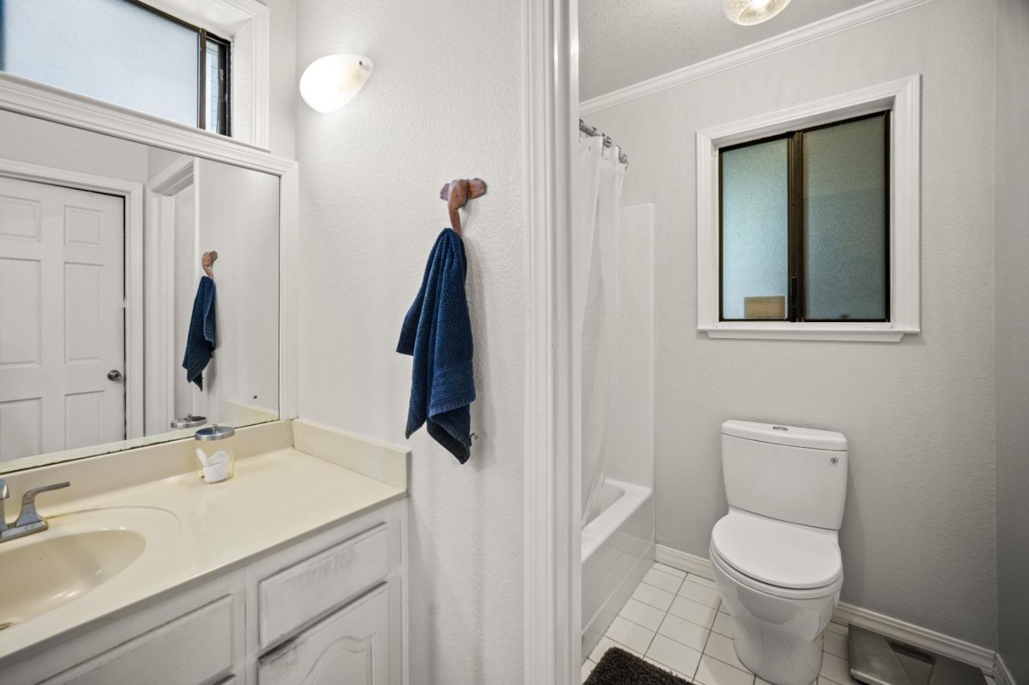 1051 Highlander Drive Seaside, CA 93955 - Photo 34 of 40 a bathroom with a toilet sink and mirror