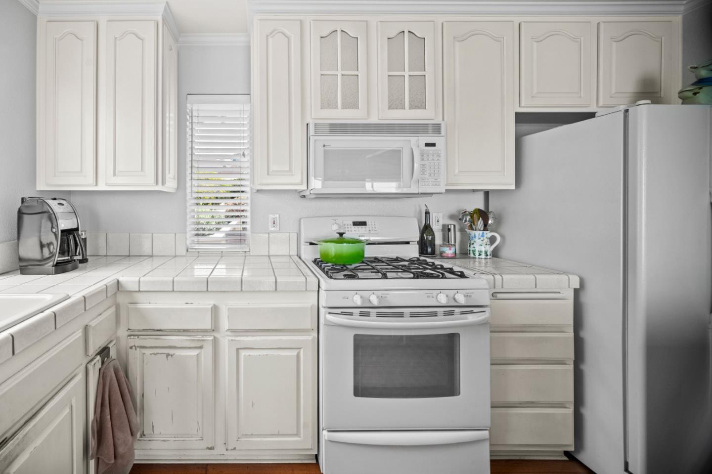 1051 Highlander Drive Seaside, CA 93955 - Photo 9 of 40 a kitchen with white cabinets and white appliances