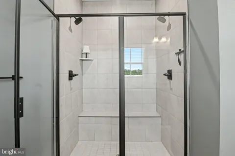 a bathroom with a glass shower door