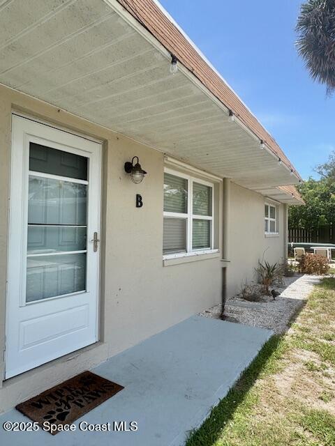 331 South Brevard Avenue, Unit B Cocoa Beach, FL 32931 - Photo 1 of 23 a front view of a house with a yard