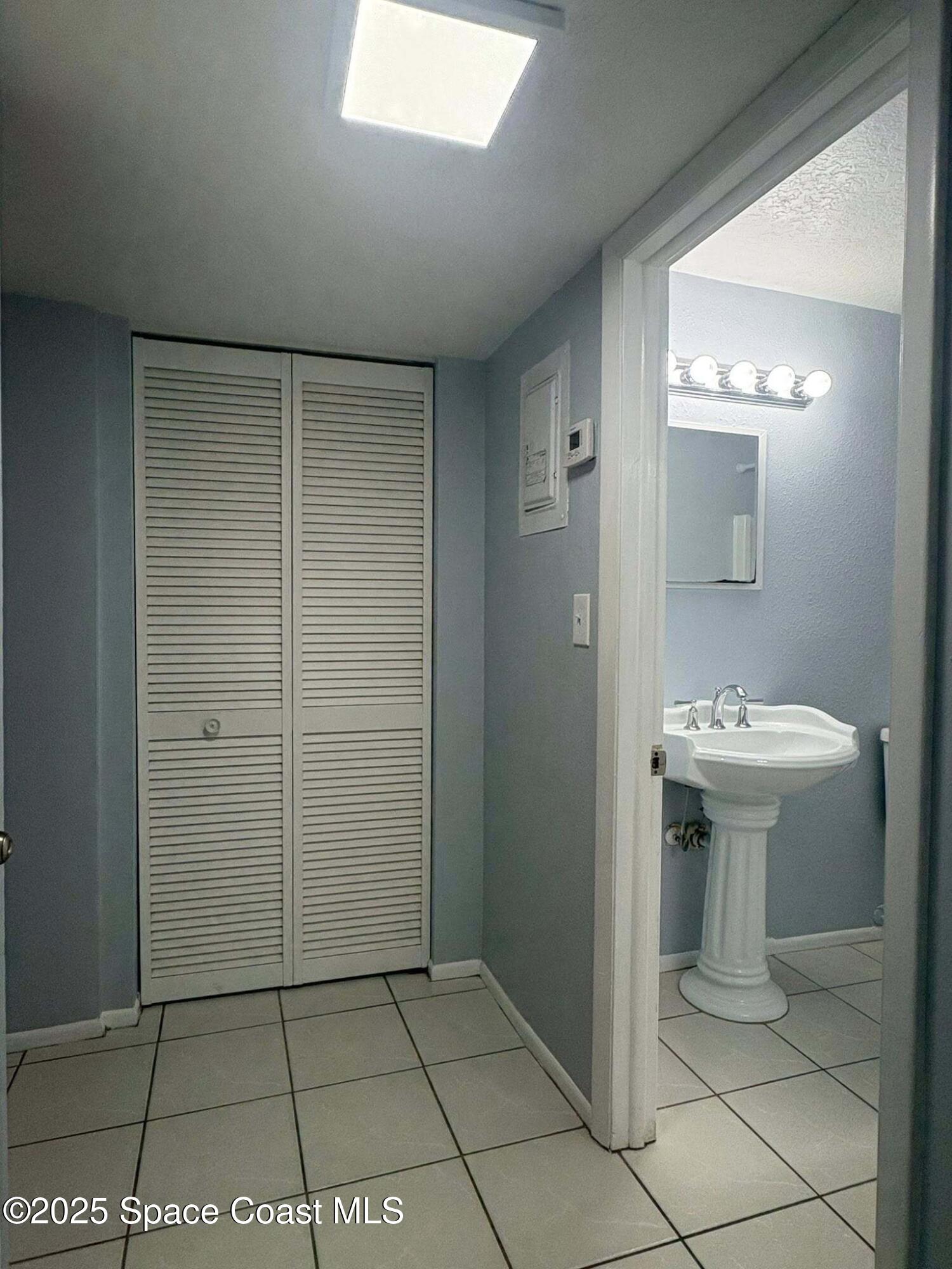 331 South Brevard Avenue, Unit B Cocoa Beach, FL 32931 - Photo 14 of 23 a bathroom with a sink a toilet and shower