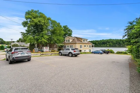 a view of a lake with a house in the background
