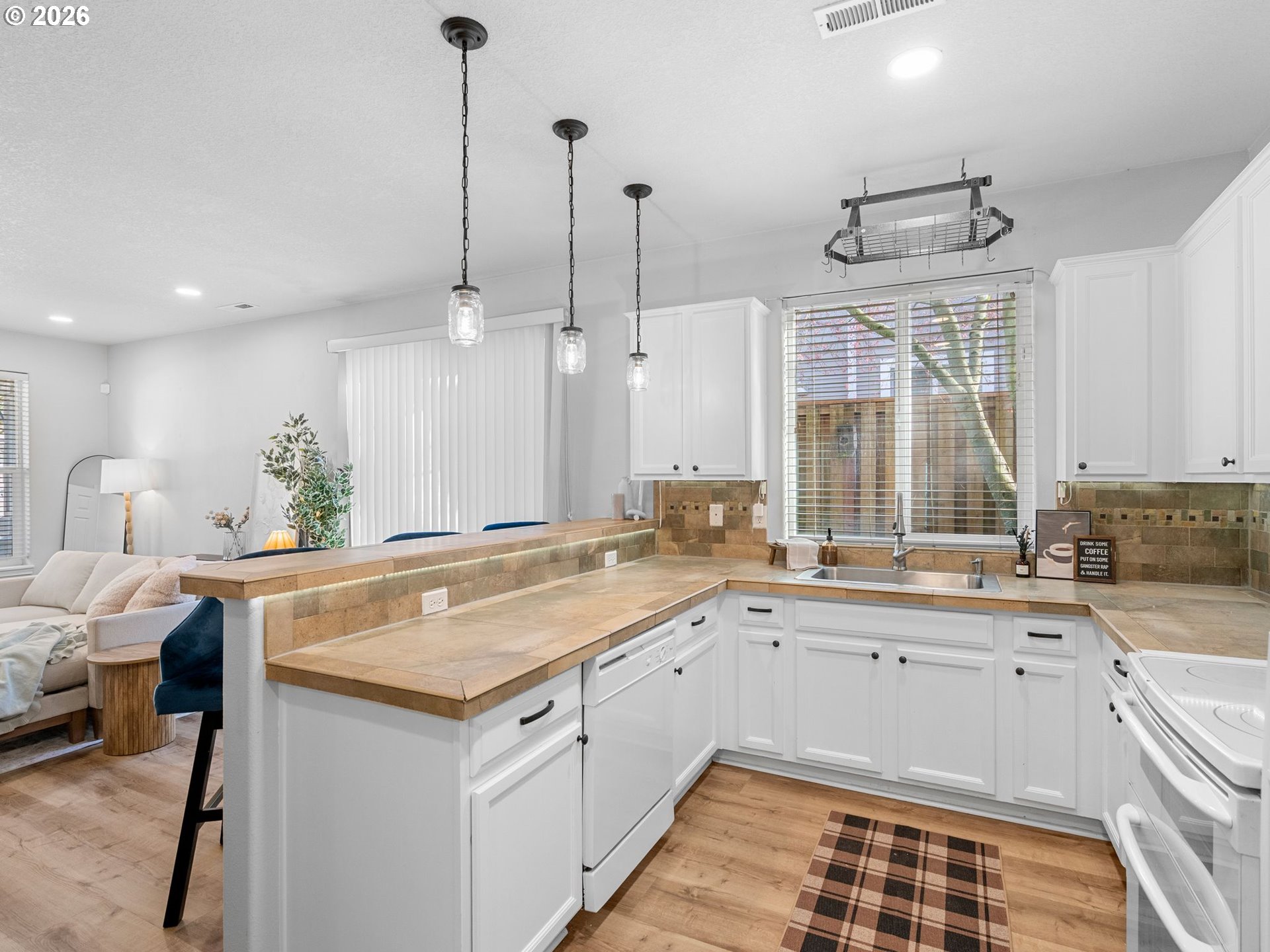 6225 Southwest 182nd Terrace Beaverton, OR 97007 - Photo 12 of 36 a kitchen with a sink stove and wooden cabinets