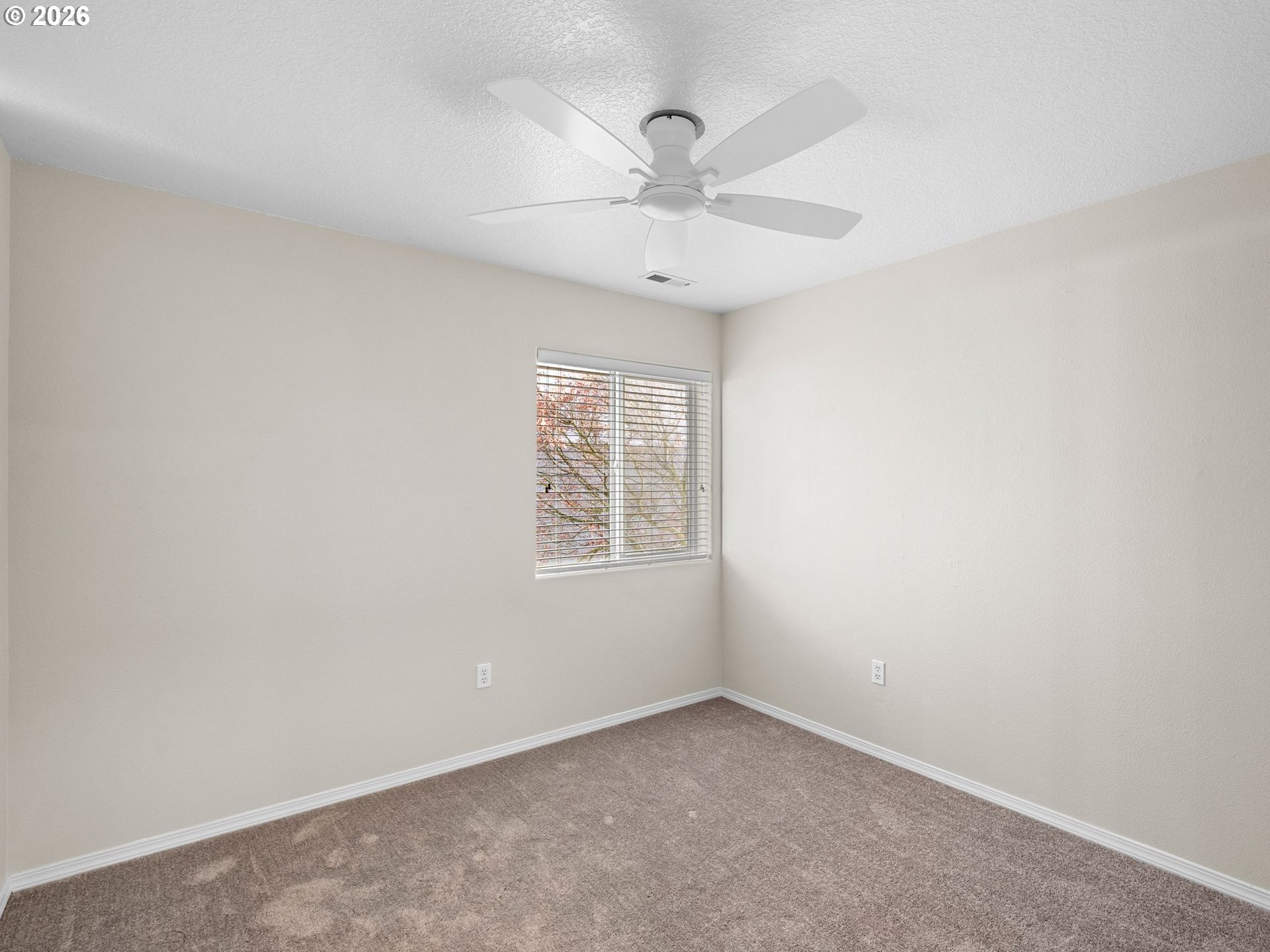 6225 Southwest 182nd Terrace Beaverton, OR 97007 - Photo 29 of 36 an empty room with a window and a fan