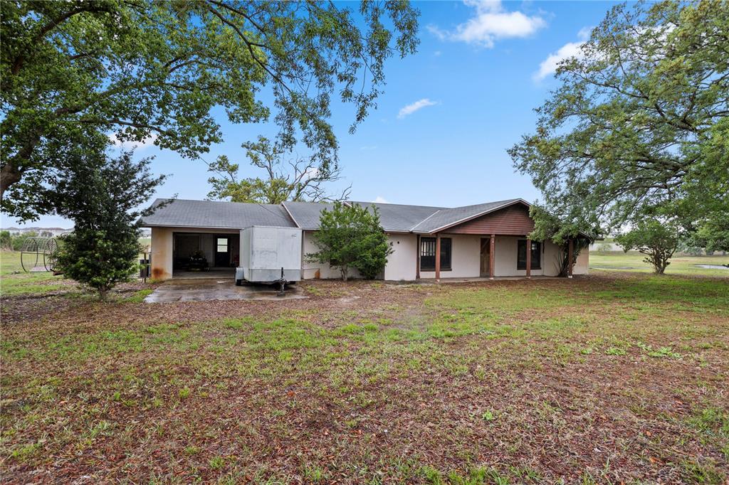 17425 Lake Ingram Road Winter Garden, FL 34787 - Photo 1 of 38 a front view of a house with a garden and trees