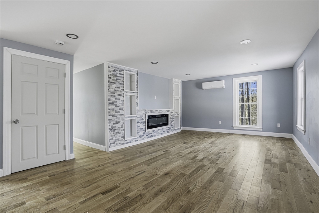 140 Spring Street Athol, MA 01331 - Photo 6 of 42 a view of an empty room with a window and wooden floor