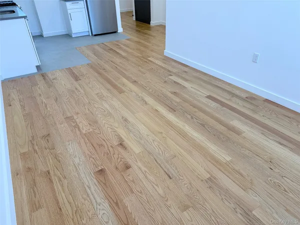a view of kitchen with refrigerator microwave and stove top oven