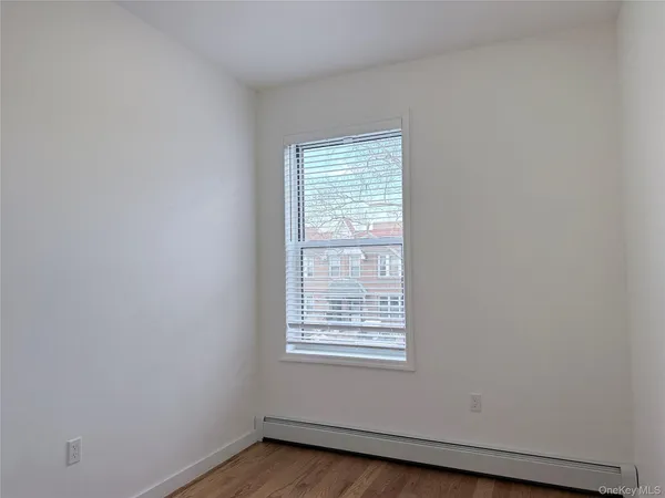 a view of room with wooden floor