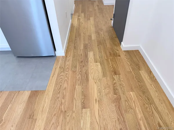a view of hallway with wooden floor