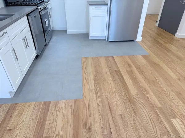 a kitchen with a refrigerator sink and cabinets