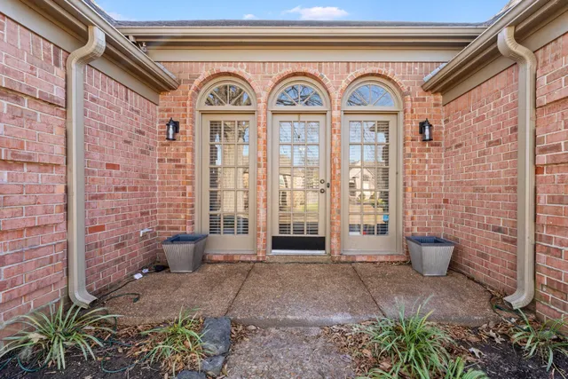 a front view of a house with outdoor seating and plants