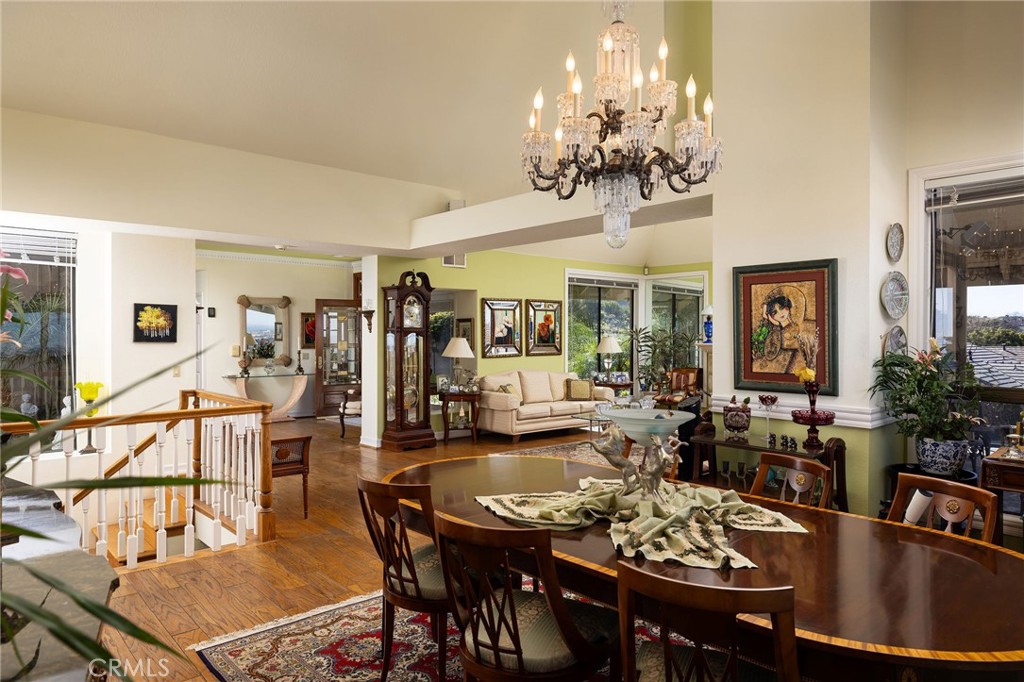 39 Harbor Ridge Drive Newport Beach, CA 92660 - Photo 15 of 53 a view of a dining room with furniture a chandelier and wooden floor