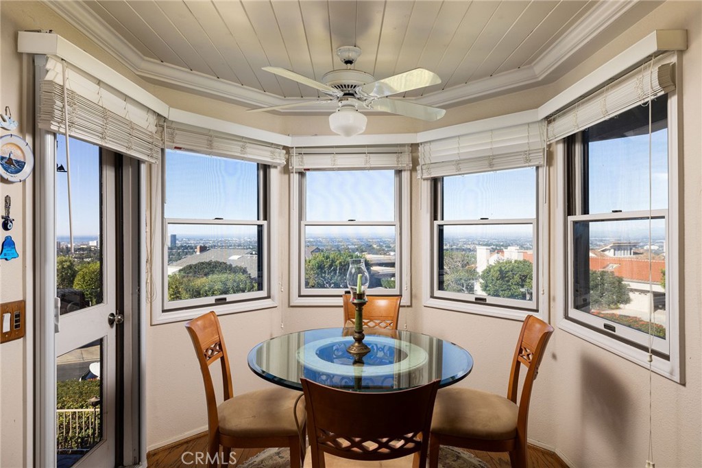 39 Harbor Ridge Drive Newport Beach, CA 92660 - Photo 18 of 53 a dining room with furniture large windows and a chandelier