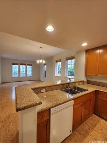 a kitchen with granite countertop sink stove and cabinets