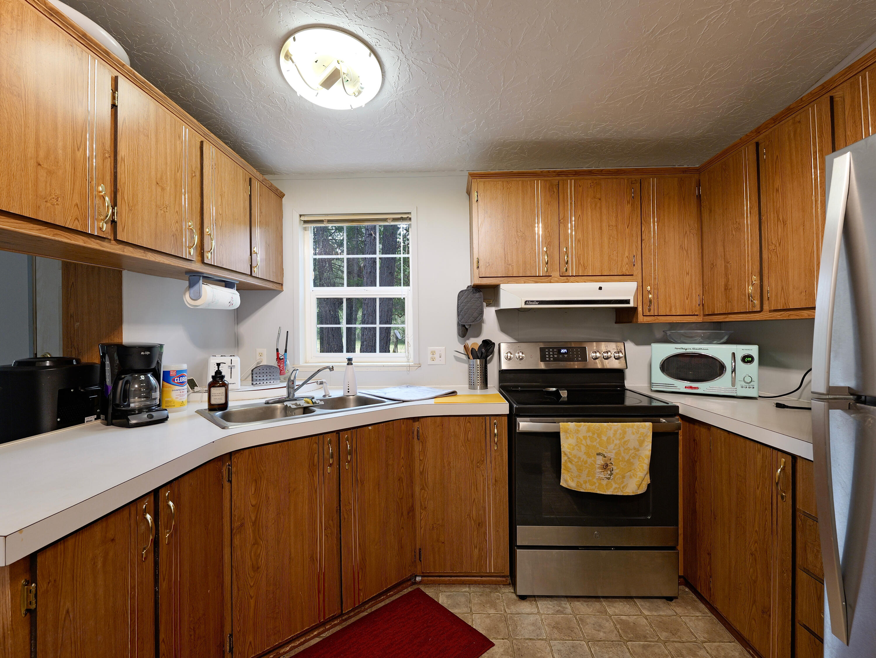 42256 Highway 62 Prospect, OR 97536 - Photo 9 of 48 a kitchen with a sink a stove cabinets and a window