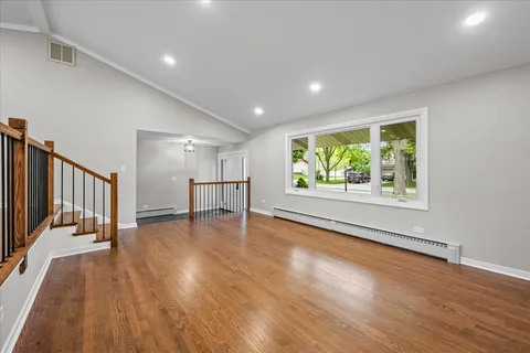 a kitchen with stainless steel appliances kitchen island granite countertop a refrigerator and a sink