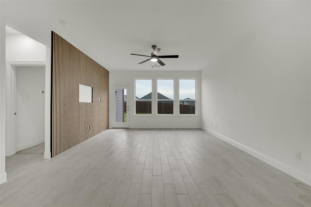2901 Isla Terrace Princeton, TX 75407 - Photo 14 of 33 an empty room with a ceiling fan and windows