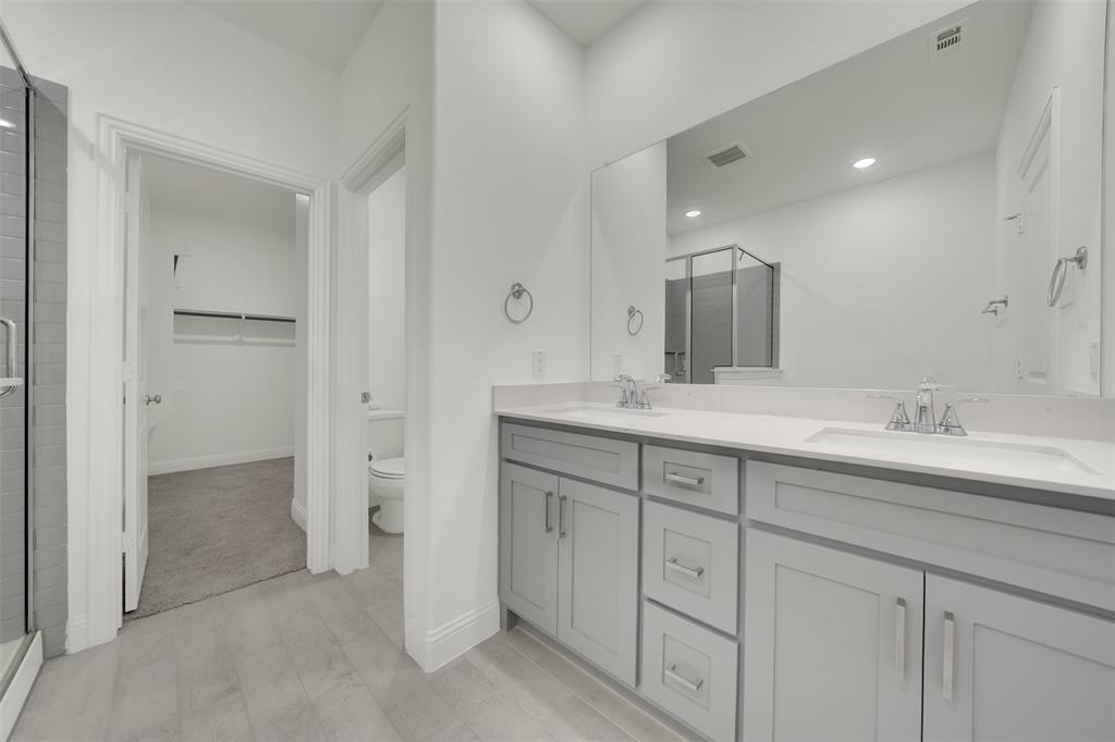 2901 Isla Terrace Princeton, TX 75407 - Photo 20 of 33 a bathroom with double sink and a mirror