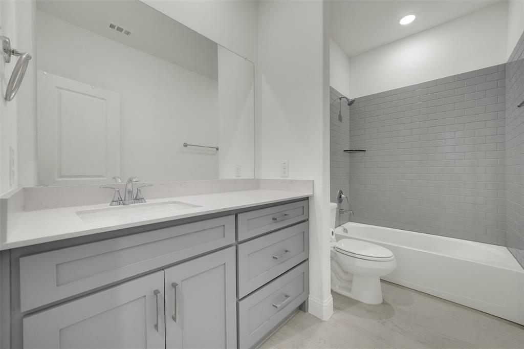 2901 Isla Terrace Princeton, TX 75407 - Photo 28 of 33 a bathroom with a granite countertop toilet a sink and a bathtub