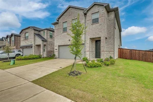 a house that has a tree in front of it