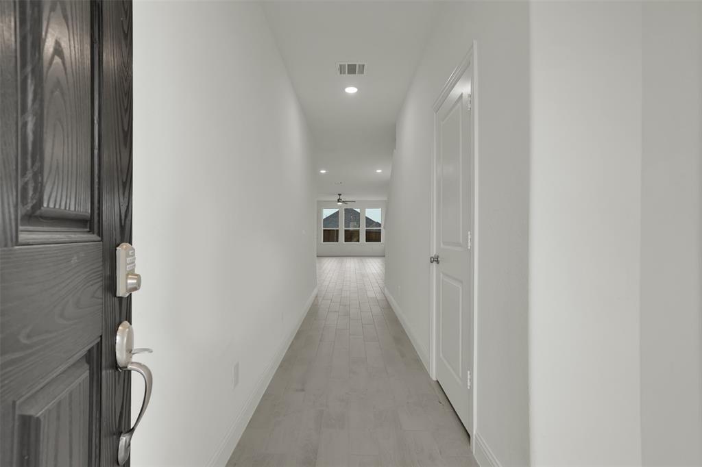 2901 Isla Terrace Princeton, TX 75407 - Photo 5 of 33 a view of a hallway with wooden floor and staircase