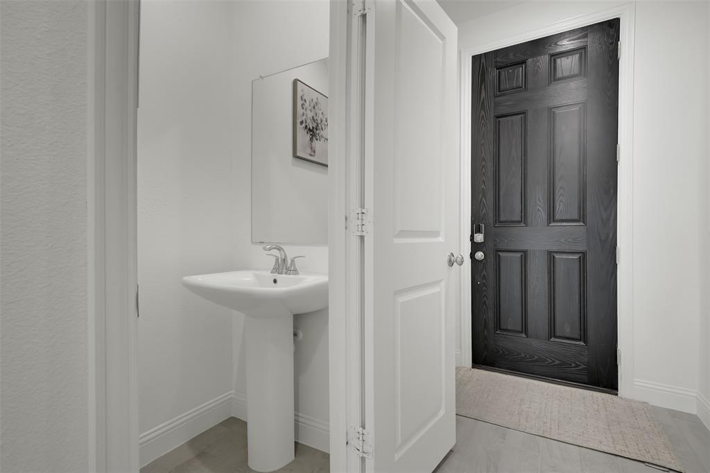 2901 Isla Terrace Princeton, TX 75407 - Photo 6 of 33 a bathroom with a sink and mirror
