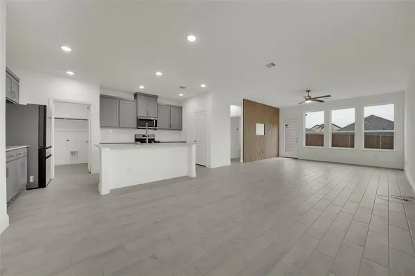 a view of a kitchen with a sink and a refrigerator