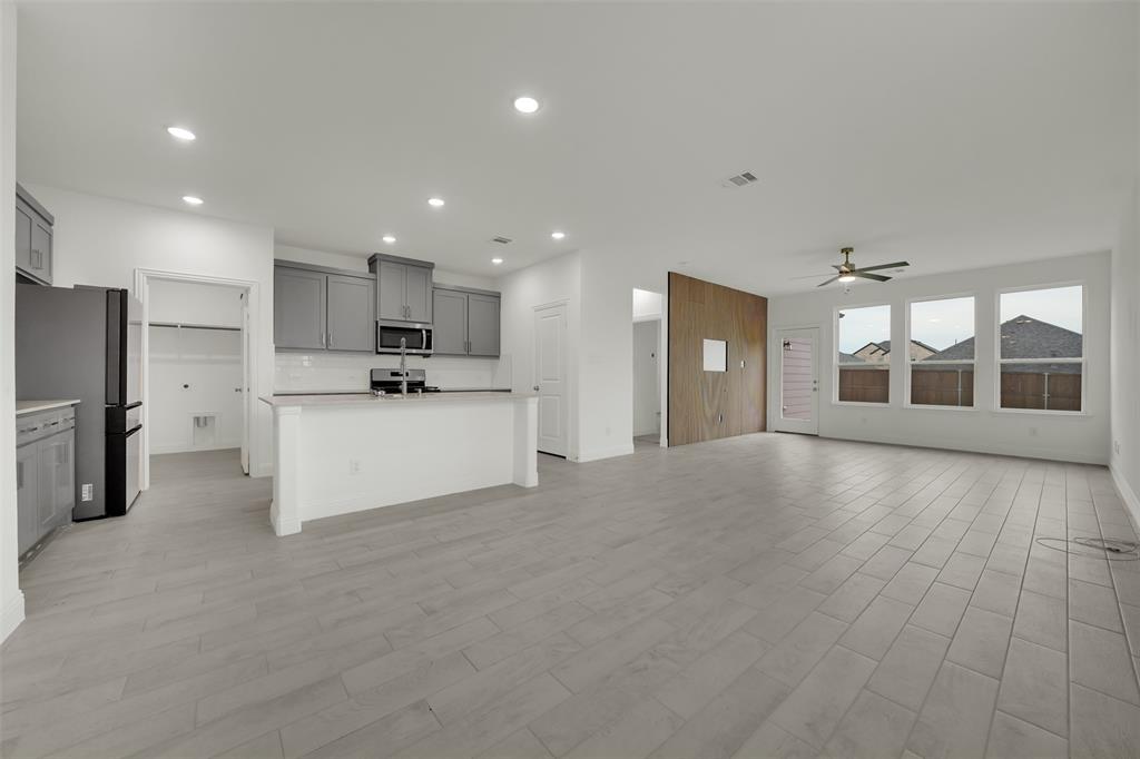 2901 Isla Terrace Princeton, TX 75407 - Photo 7 of 33 a view of a kitchen with a sink and a refrigerator