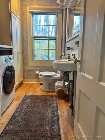 a bathroom with a tub sink and mirror